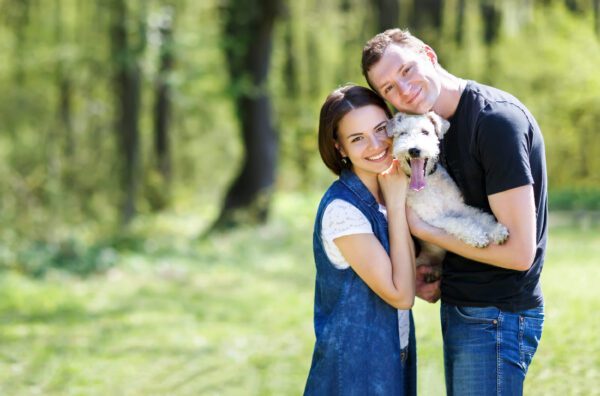 Airedale Terrier With Happy Couple Outdoors