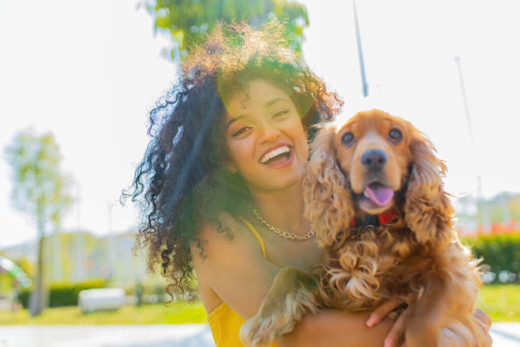 English Cocker Spaniel Posing Happily With A Smiling Woman Outdoors