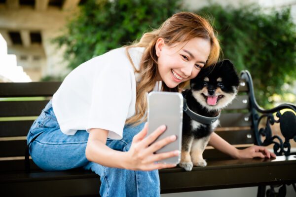 Pomsky With Owner Taking Selfie Outdoors