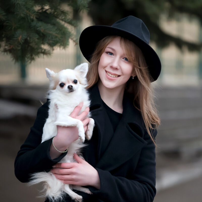 woman holding long haired chihuahua outside in new york