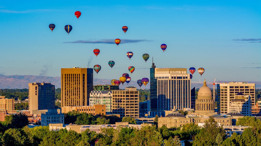 hot air balloons flying over downtown Boise