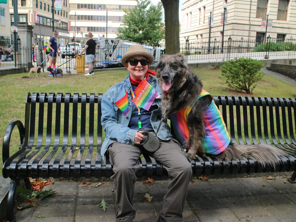 woman and dog on park bench