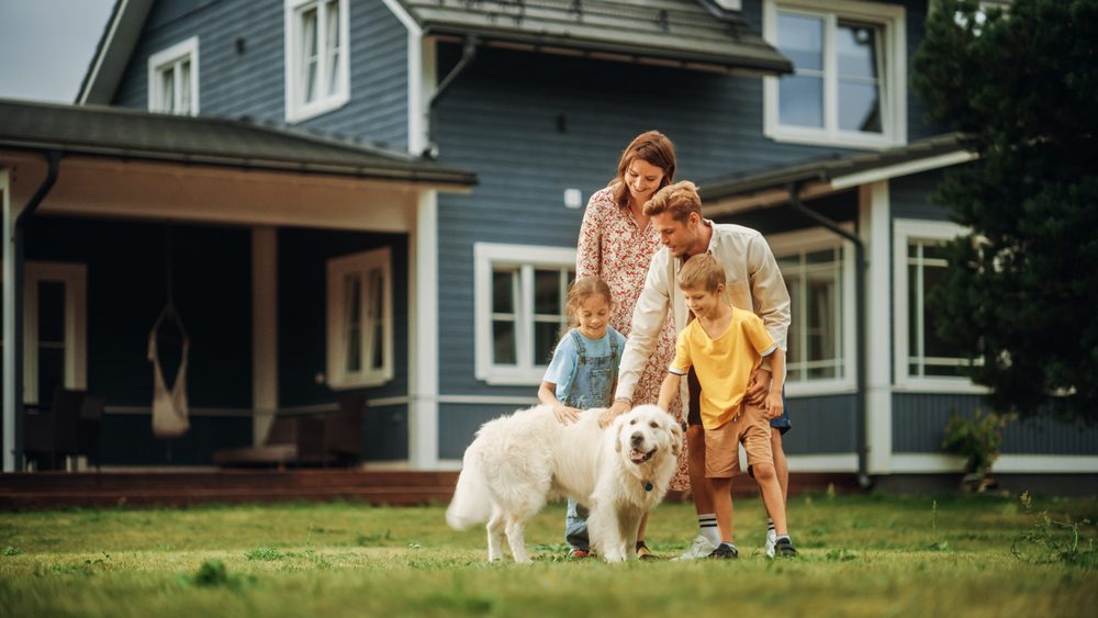 family petting their golden retriever